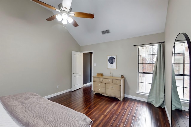 bedroom featuring visible vents, lofted ceiling, baseboards, multiple windows, and dark wood-type flooring