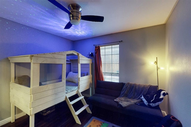 bedroom with baseboards, ceiling fan, and wood finished floors