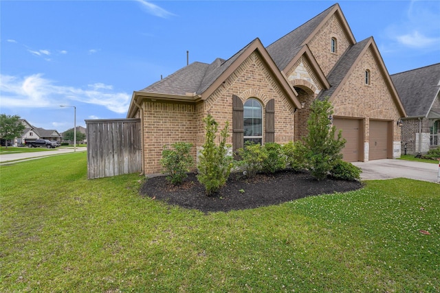 2321 Mayfield Trail Ct, League City, TX 77573 - view of front of property with roof with shingles, an attached garage, a front lawn, brick siding, and driveway