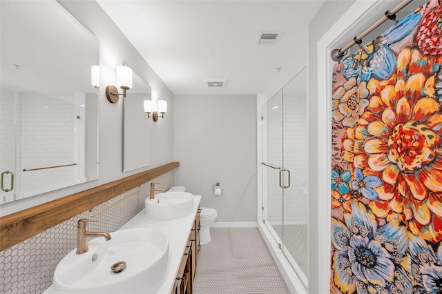 204 Travis St Unit 4A, Houston, TX 77002 - full bath featuring a sink, a shower stall, double vanity, and visible vents