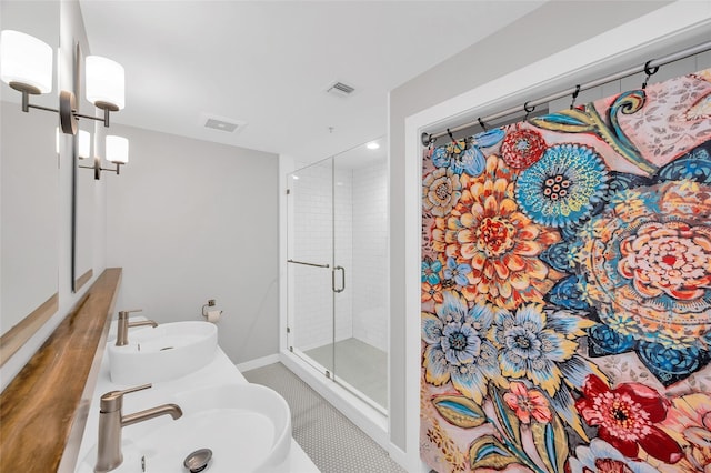 204 Travis St Unit 4A, Houston, TX 77002 - full bath with baseboards, a shower stall, dual sinks, and visible vents