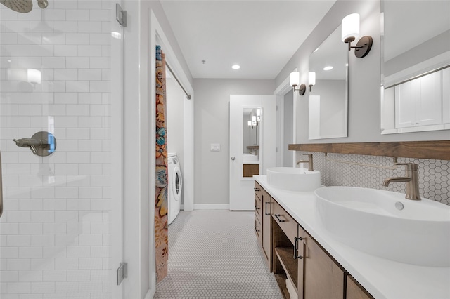 204 Travis St Unit 4A, Houston, TX 77002 - full bath featuring tile patterned flooring, a sink, washer / dryer, and tasteful backsplash