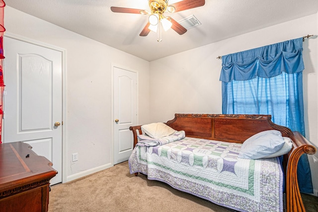carpeted bedroom featuring baseboards, visible vents, and ceiling fan