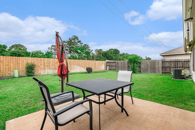 view of patio featuring central air condition unit, outdoor dining area, and a fenced backyard