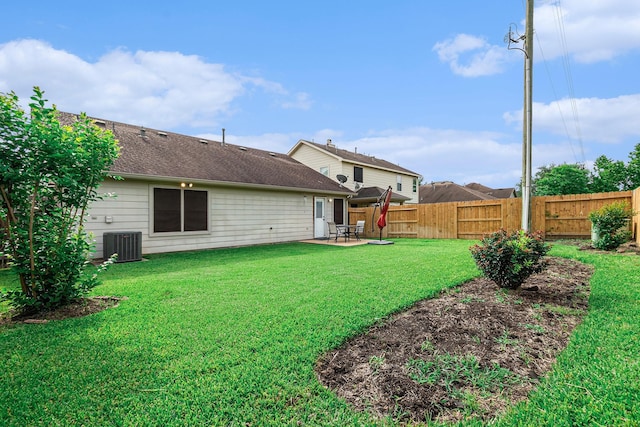 view of yard featuring a fenced backyard, a patio area, and central air condition unit