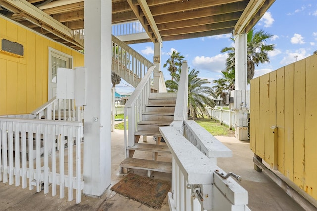 view of patio / terrace with fence and stairs