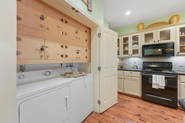 laundry area featuring light wood-type flooring, recessed lighting, cabinet space, and washing machine and clothes dryer