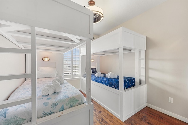 bedroom featuring baseboards and wood finished floors