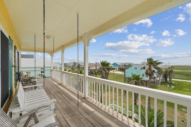 deck with a yard and a residential view