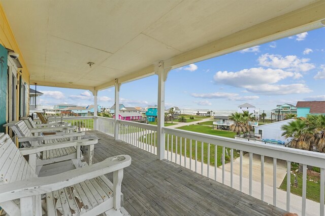 wooden deck with a residential view and a yard