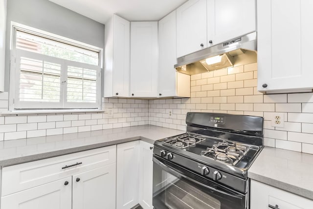 kitchen with under cabinet range hood, white cabinetry, gas stove, and tasteful backsplash