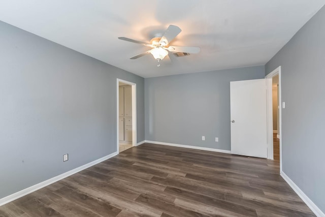 empty room featuring ceiling fan, dark wood finished floors, and visible vents