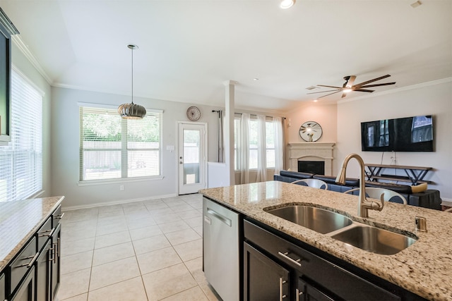 kitchen with a sink, a fireplace, open floor plan, stainless steel dishwasher, and ornamental molding