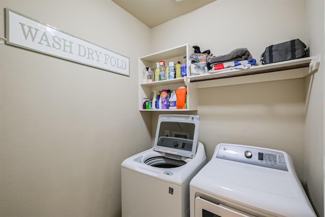 laundry area featuring separate washer and dryer and laundry area