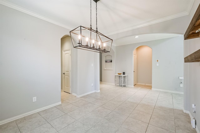 unfurnished dining area with arched walkways, a chandelier, baseboards, light tile patterned floors, and ornamental molding