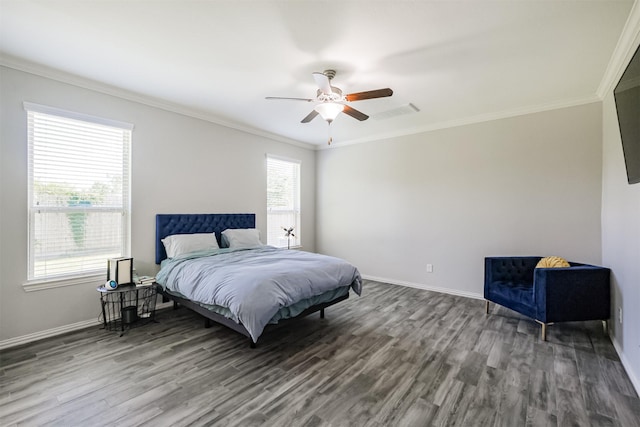 bedroom featuring crown molding, visible vents, wood finished floors, baseboards, and ceiling fan