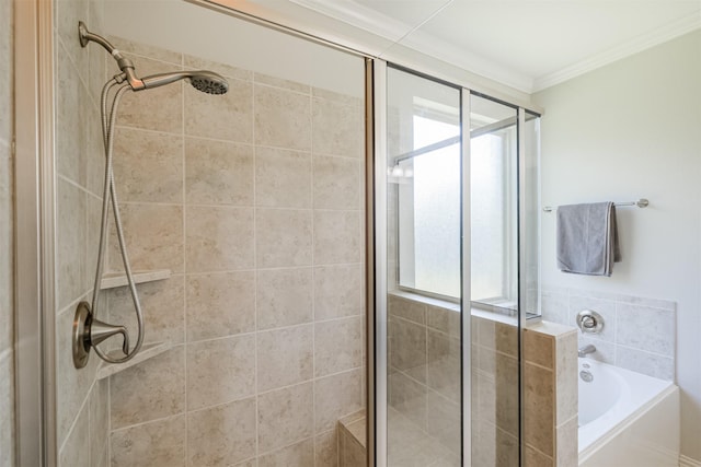 bathroom featuring ornamental molding, a bath, and a stall shower