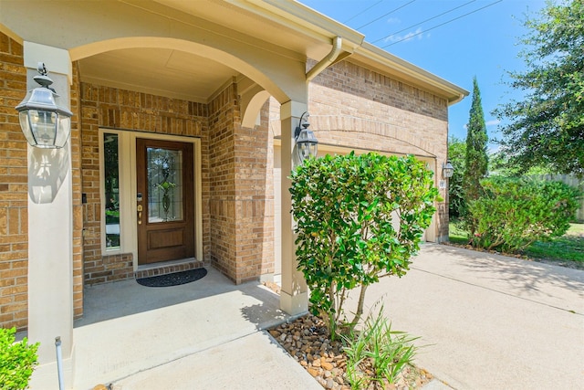 doorway to property featuring brick siding