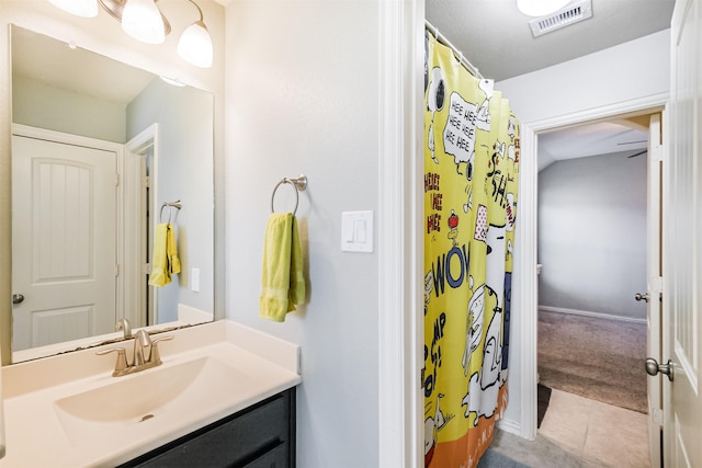 bathroom with visible vents, curtained shower, tile patterned flooring, and vanity