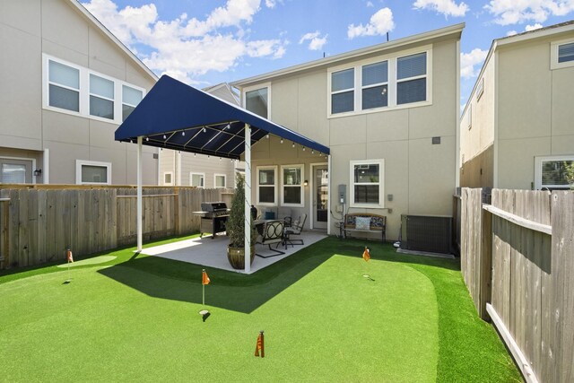 9904 Smokehouse Silo Ln, Houston, TX 77080 - rear view of house with an area to practice putting, a fenced backyard, a patio, and stucco siding