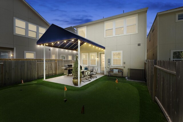 9904 Smokehouse Silo Ln, Houston, TX 77080 - back of house featuring a putting green, a patio area, and a fenced backyard