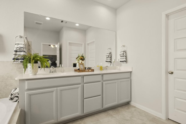 9904 Smokehouse Silo Ln, Houston, TX 77080 - bathroom featuring double vanity, tiled bath, recessed lighting, tile patterned flooring, and baseboards