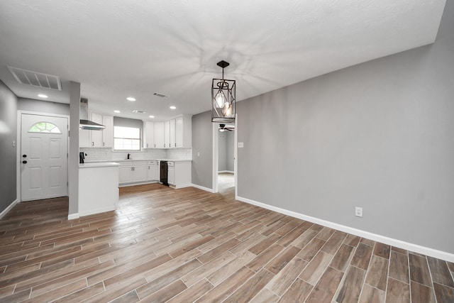 unfurnished living room featuring recessed lighting, baseboards, light wood-type flooring, and visible vents