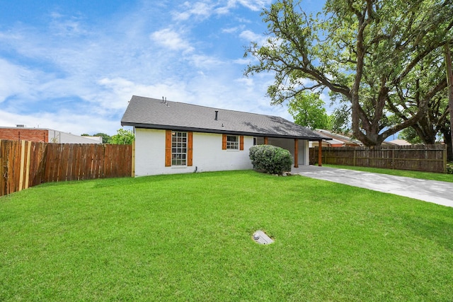 ranch-style home with a garage, fence, driveway, and a front yard