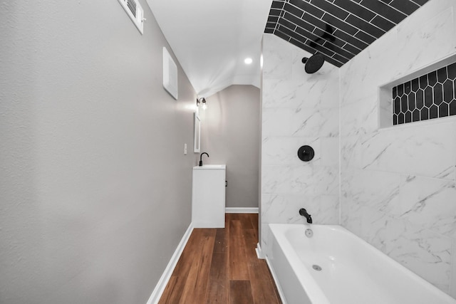 full bath with vanity, baseboards, tub / shower combination, wood finished floors, and visible vents