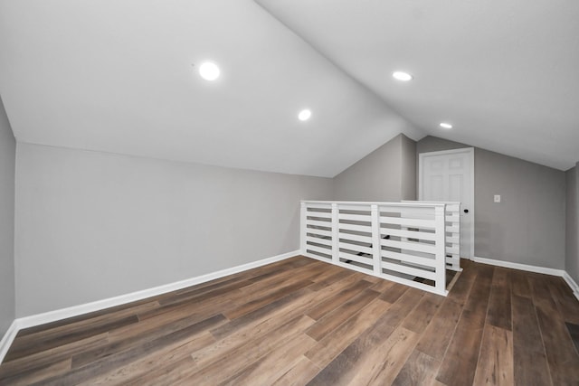 bonus room with baseboards, dark wood-type flooring, recessed lighting, and lofted ceiling