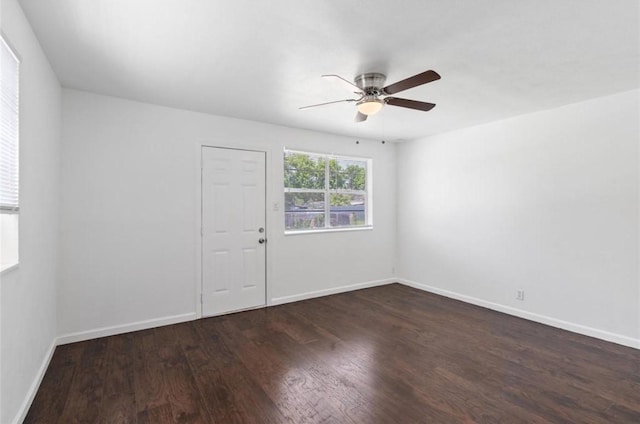 empty room with baseboards, a ceiling fan, and wood finished floors