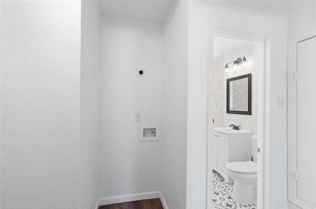 bathroom featuring vanity, baseboards, wood finished floors, and toilet