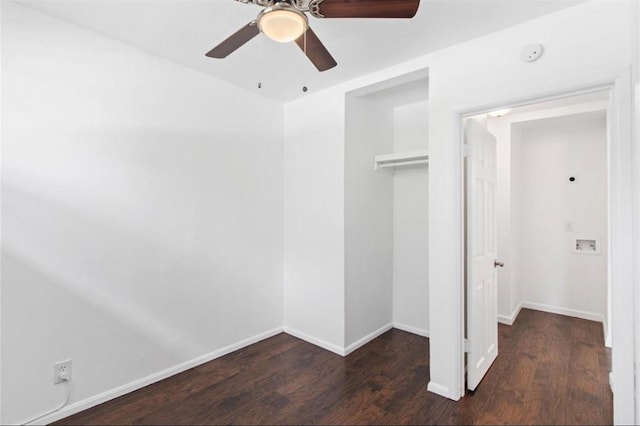 unfurnished bedroom with baseboards, wood finished floors, and a closet