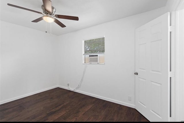 empty room featuring baseboards, ceiling fan, cooling unit, and dark wood-type flooring