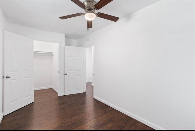 unfurnished bedroom featuring baseboards, a ceiling fan, a closet, and wood finished floors