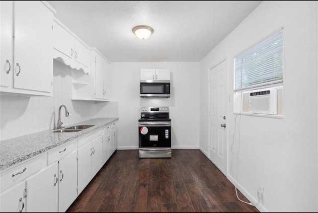 kitchen featuring dark wood-style flooring, appliances with stainless steel finishes, a sink, cooling unit, and white cabinetry