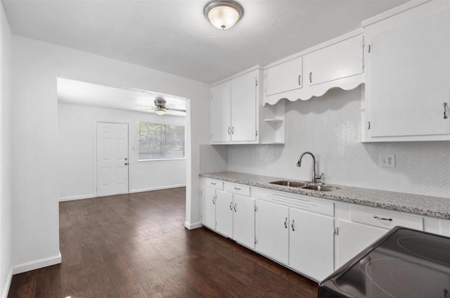kitchen featuring white cabinetry, range with electric cooktop, dark wood-style floors, and a sink