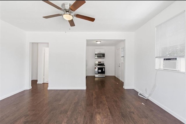 unfurnished room featuring baseboards, a ceiling fan, cooling unit, and dark wood-style floors