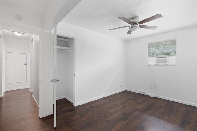 unfurnished bedroom with a ceiling fan, baseboards, wood finished floors, and cooling unit