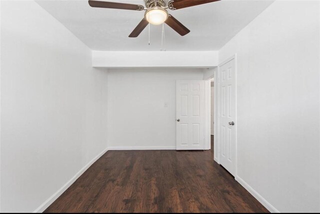 spare room with baseboards, a ceiling fan, and wood finished floors