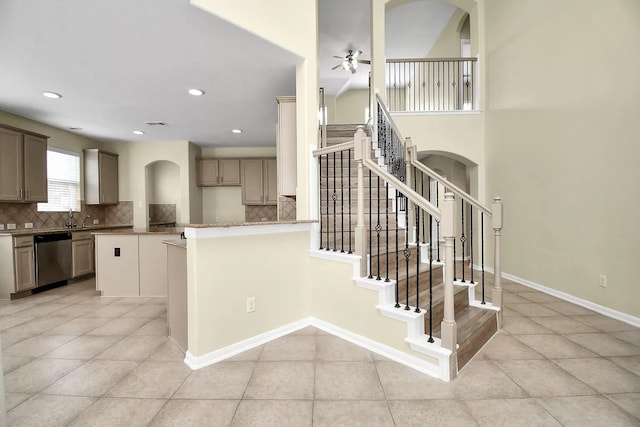 6315 Bain Dr, Missouri City, TX 77459 - kitchen featuring stainless steel dishwasher, light tile patterned flooring, and tasteful backsplash