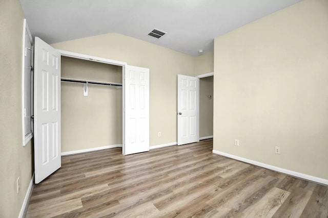 6315 Bain Dr, Missouri City, TX 77459 - unfurnished bedroom with visible vents, vaulted ceiling, wood finished floors, baseboards, and a closet
