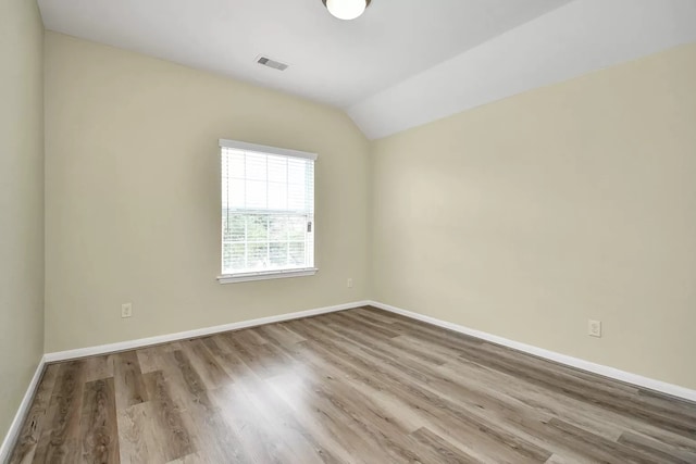 6315 Bain Dr, Missouri City, TX 77459 - empty room with visible vents, baseboards, wood finished floors, and vaulted ceiling
