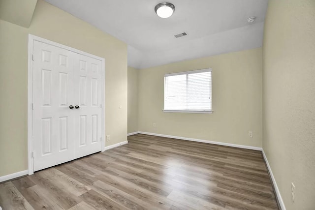 6315 Bain Dr, Missouri City, TX 77459 - unfurnished bedroom featuring baseboards, visible vents, wood finished floors, and a closet
