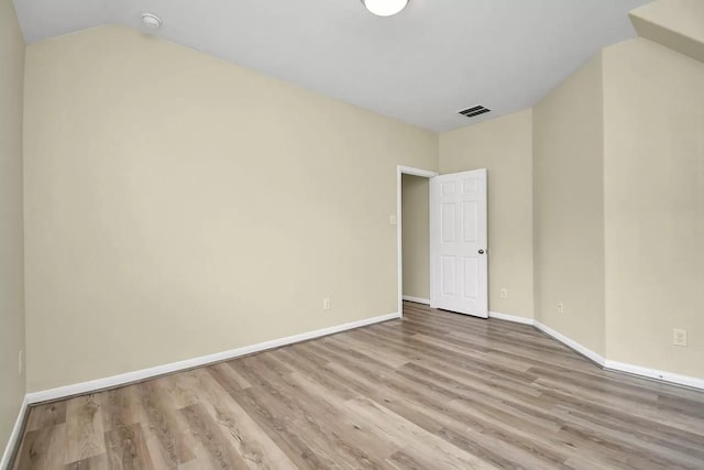 6315 Bain Dr, Missouri City, TX 77459 - unfurnished room featuring baseboards, lofted ceiling, wood finished floors, and visible vents
