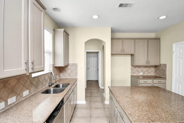 6315 Bain Dr, Missouri City, TX 77459 - kitchen with a sink, arched walkways, light tile patterned floors, stainless steel dishwasher, and visible vents