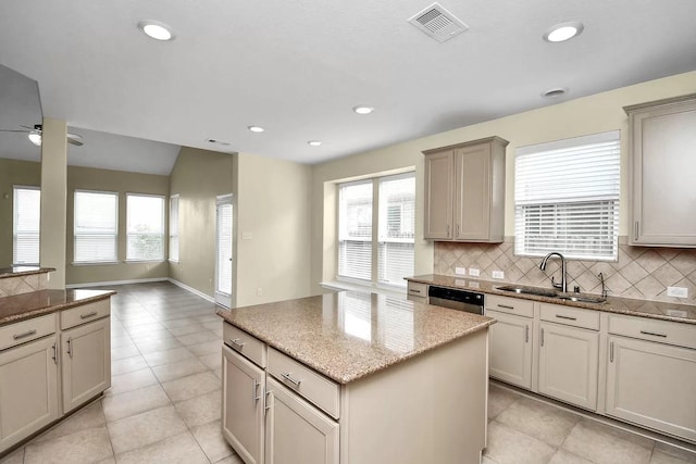6315 Bain Dr, Missouri City, TX 77459 - kitchen with a sink, a center island, a ceiling fan, and backsplash