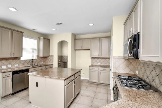 6315 Bain Dr, Missouri City, TX 77459 - kitchen featuring backsplash, visible vents, a sink, light stone counters, and stainless steel appliances