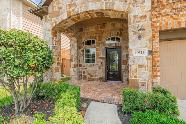 property entrance with brick siding and stone siding
