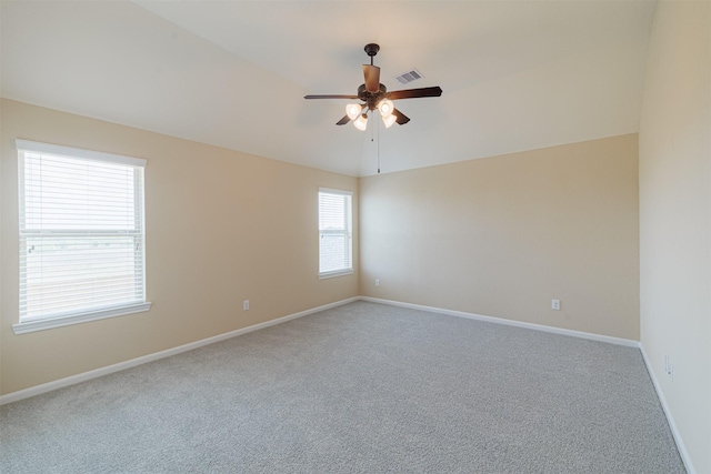 unfurnished room with ceiling fan, baseboards, and carpet